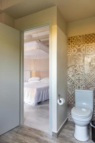 a bathroom with a toilet and a bed at NEW - Villa Manika - 3BR 3BA Pool in Agia Fotia