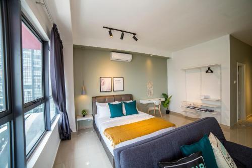 a bedroom with a bed and a couch at Arte Plus KLCC Designer Suites by Cobnb in Kuala Lumpur