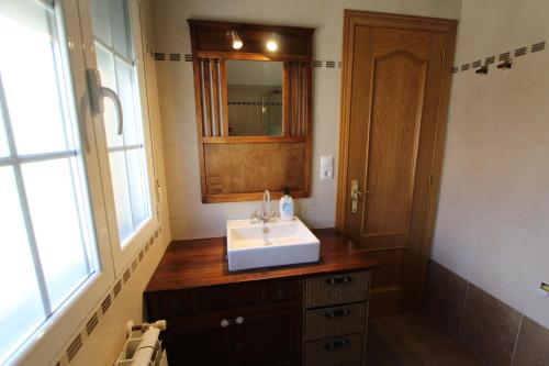 a bathroom with a sink and a mirror at Las Riendas casa rural in Muñeca