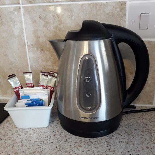 a black and silver tea kettle sitting on a counter at Lucea Cottage in Craven Arms