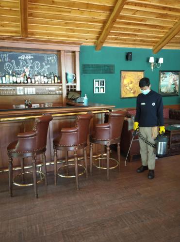 a man wearing a mask standing in a bar at Araiya Palampur in Pālampur