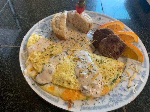 a plate of breakfast food with eggs and bread at Peace & Plenty Inn Bed and Breakfast Downtown St Augustine-Adults Only in Saint Augustine