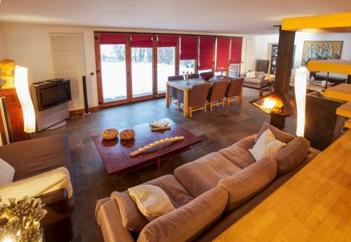 a living room with a couch and a table at L'appart du chateau des Girards in Lans-en-Vercors