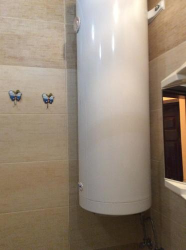 a shower with a white tank in a bathroom at Marina Studio in Burgas