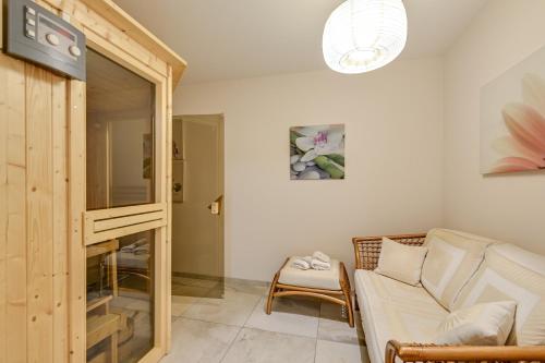 a living room with a couch and a mirror at Ferienwohnung Panorama Eg in Inzell