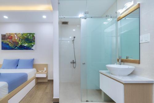a bathroom with a bed and a sink and a shower at Cozrum Homes - Yoga Corner in Ho Chi Minh City