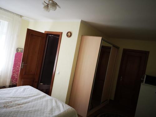 a bedroom with two closets and a bed in it at Sadyba Anzhelika in Truskavets