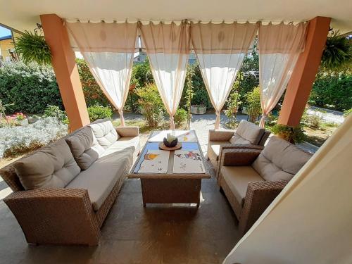 a living room with two couches and a table at Villa Bruna in Cesenatico