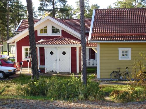 a red and yellow house with a bike in front of it at Östersunds Camping in Östersund
