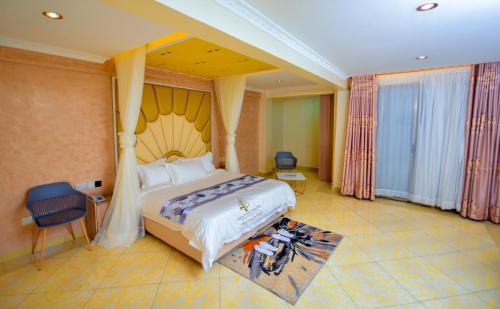 a hotel room with a bed and a chair at Deuts Four Seasons Hotel in Nairobi