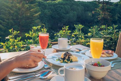 a table with plates of food and drinks on it at Iberostar Waves Royal Andalus in Chiclana de la Frontera