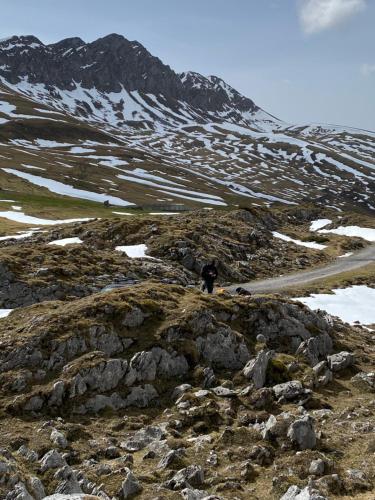 a person walking on a rocky mountain at Le petit Monrepos avec jacuzzi nordique in Bielle