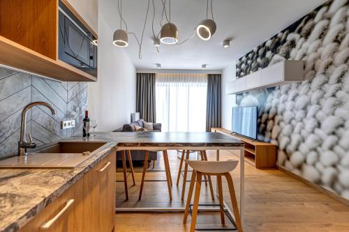 a kitchen with a table and a counter top at RentApart by Cotton House in Łódź
