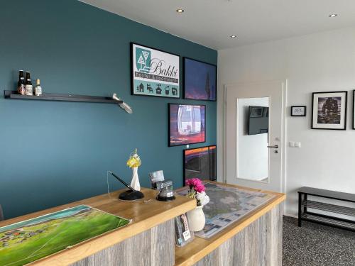 a desk in a room with a blue wall at Bakki Apartments & Hostel in Eyrarbakki