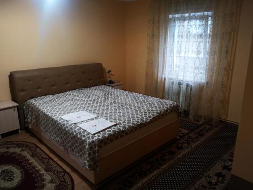 a bedroom with a bed and a window with curtains at Sadyba Anzhelika in Truskavets