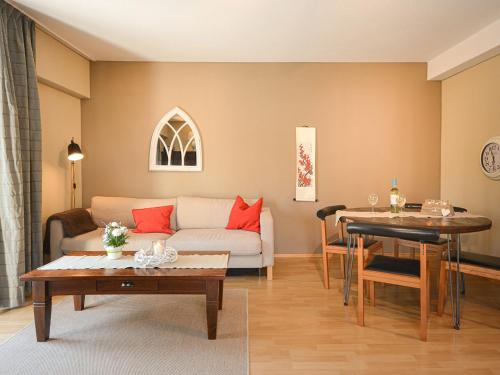 a living room with a couch and a table at ABACCO Ferienwohnungen in Überlingen