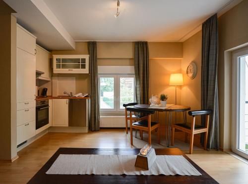a kitchen and dining room with a table and a window at ABACCO Ferienwohnungen in Überlingen