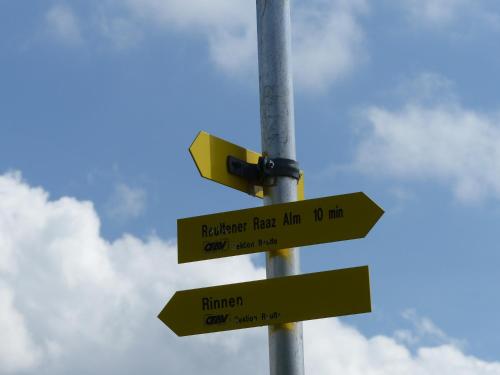 a street sign with street signs on a pole at Haus Resi in Berwang