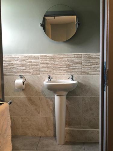 a bathroom with a sink and a mirror at Al Forno Restaurant & Inn in Norwich