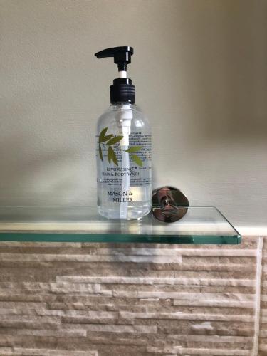 a bottle of mouthwash sitting on a glass table at Al Forno Restaurant & Inn in Norwich