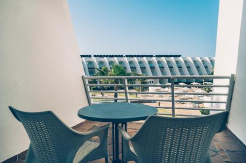 a table and two chairs on a balcony at Iberostar Waves Royal Andalus in Chiclana de la Frontera