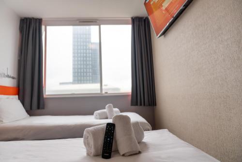 a hotel room with two beds and a window at easyHotel Croydon in Croydon