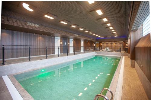 a large swimming pool in a large building at Laponia Hotell & Konferens in Arvidsjaur