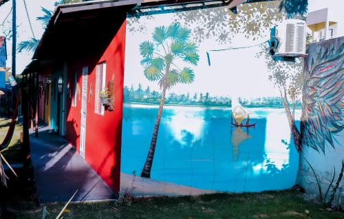 a mural of a palm tree on the side of a building at Casa do Mestre Avila in Jijoca de Jericoacoara