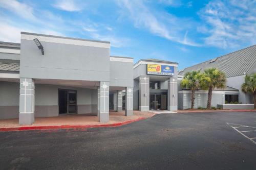 an empty parking lot in front of a building at Super 8 by Wyndham Mobile I-65 in Mobile