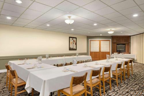 a conference room with white tables and chairs at Days Inn by Wyndham Nanaimo in Nanaimo