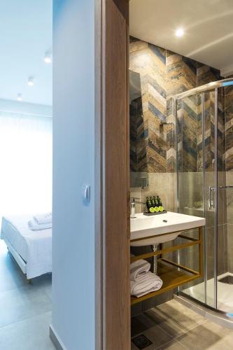 a bathroom with a sink and a shower at Motivo Thassos in Skala Potamias