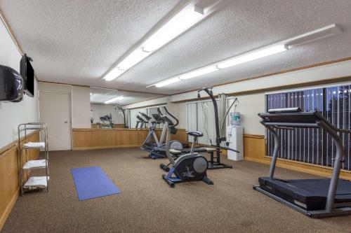 a gym with several exercise bikes and a treadmill at Ramada by Wyndham Coquitlam in Coquitlam