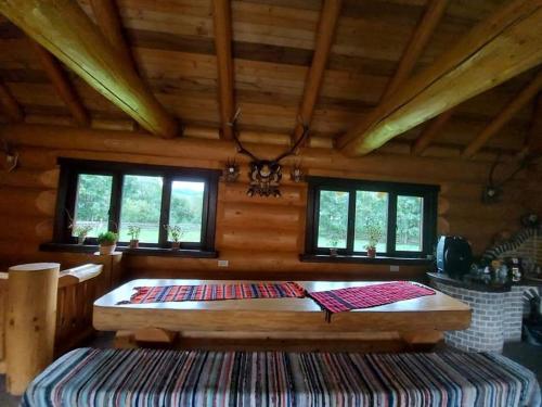 a bedroom with a large bed in a cabin at Pensiunea Argela in Argel