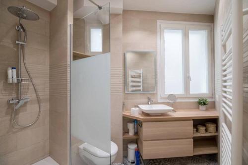 a bathroom with a shower and a sink and a toilet at Cosy and spacious apartment near Champs Elysée in Paris