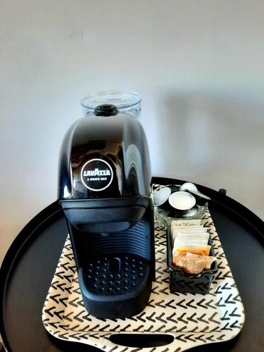 a coffee maker sitting on top of a table at Casa Tina Holiday Home in Diano dʼAlba