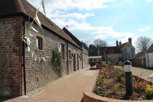 a brick building with a sidewalk next to a street at YHA South Downs in Lewes