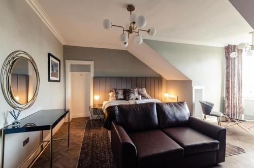 a living room with a couch and a bed at Sweeney Motherwell in Motherwell