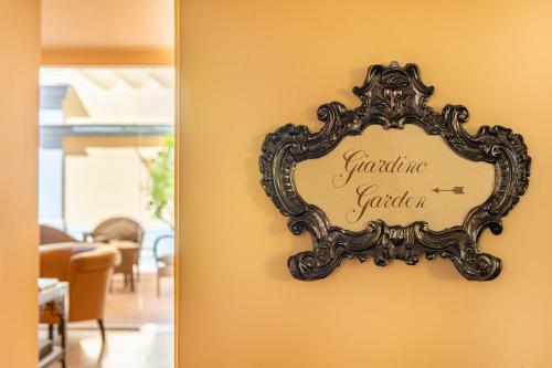 a mirror hanging on a wall in a dining room at Hotel S. Anna in Rome