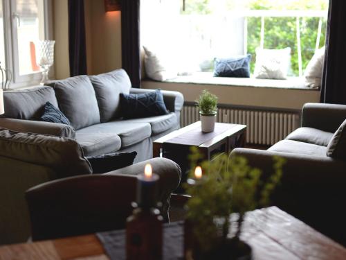 a living room with couches and a table and a window at ABACCO Ferienwohnungen in Überlingen
