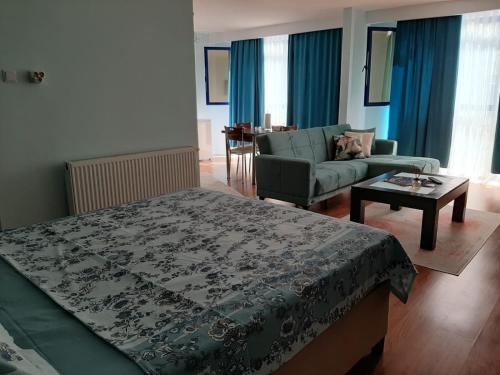 a bedroom with a bed and a couch and a table at Samlife Apart in Samsun