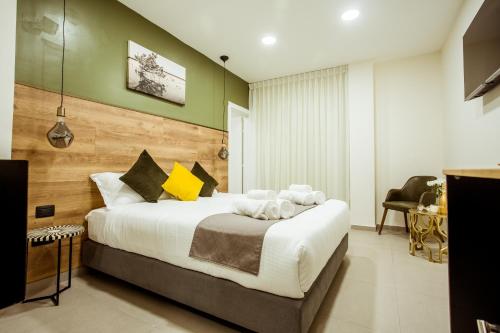 a bedroom with a large bed in a room at The Negev Hotel By Domus in Beer Sheva