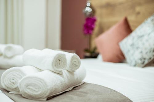 a pile of towels sitting on top of a bed at The Negev Hotel By Domus in Beer Sheva
