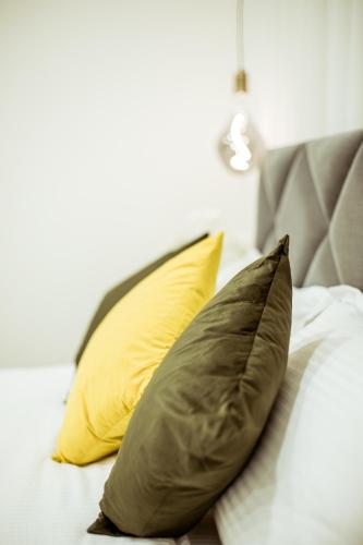 two pillows sitting on top of a bed at The Negev Hotel By Domus in Beer Sheva