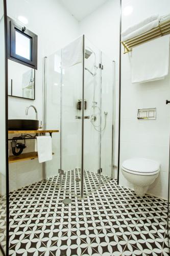 a bathroom with a shower and a toilet at The Negev Hotel By Domus in Beer Sheva