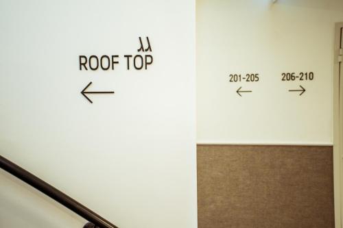 a room with a rock top sign on the wall at The Negev Hotel By Domus in Beer Sheva