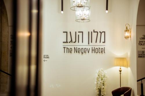 a sign for the mercy hotel on a wall at The Negev Hotel By Domus in Beer Sheva