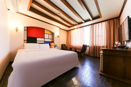a hotel room with a large bed and a television at Nova Motel in Boryeong