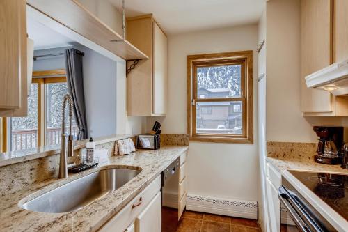 a kitchen with a sink and a window at Mount Royal Condos #501 condo in Frisco