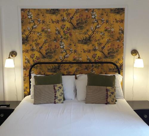 a bedroom with a large bed with a yellow wall at Room Only Corbies Rest in Inverness