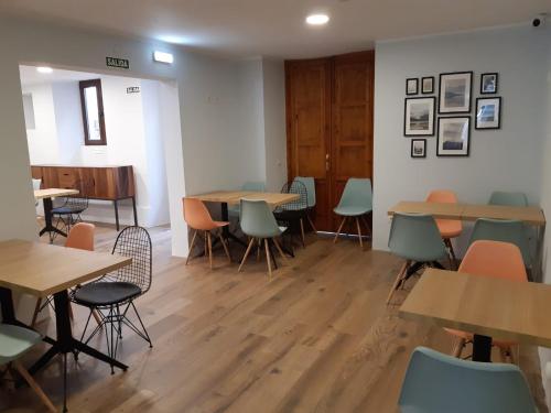 リャネスにあるHotel Puerto de Llanesの木製のテーブルと椅子、デスクと椅子が備わる客室です。